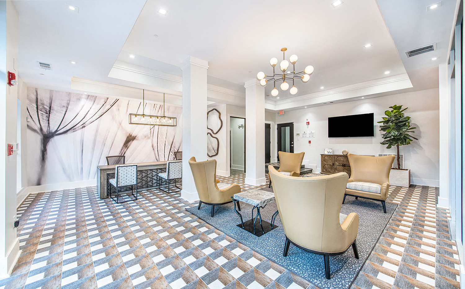 a lobby with chairs and a table and a television