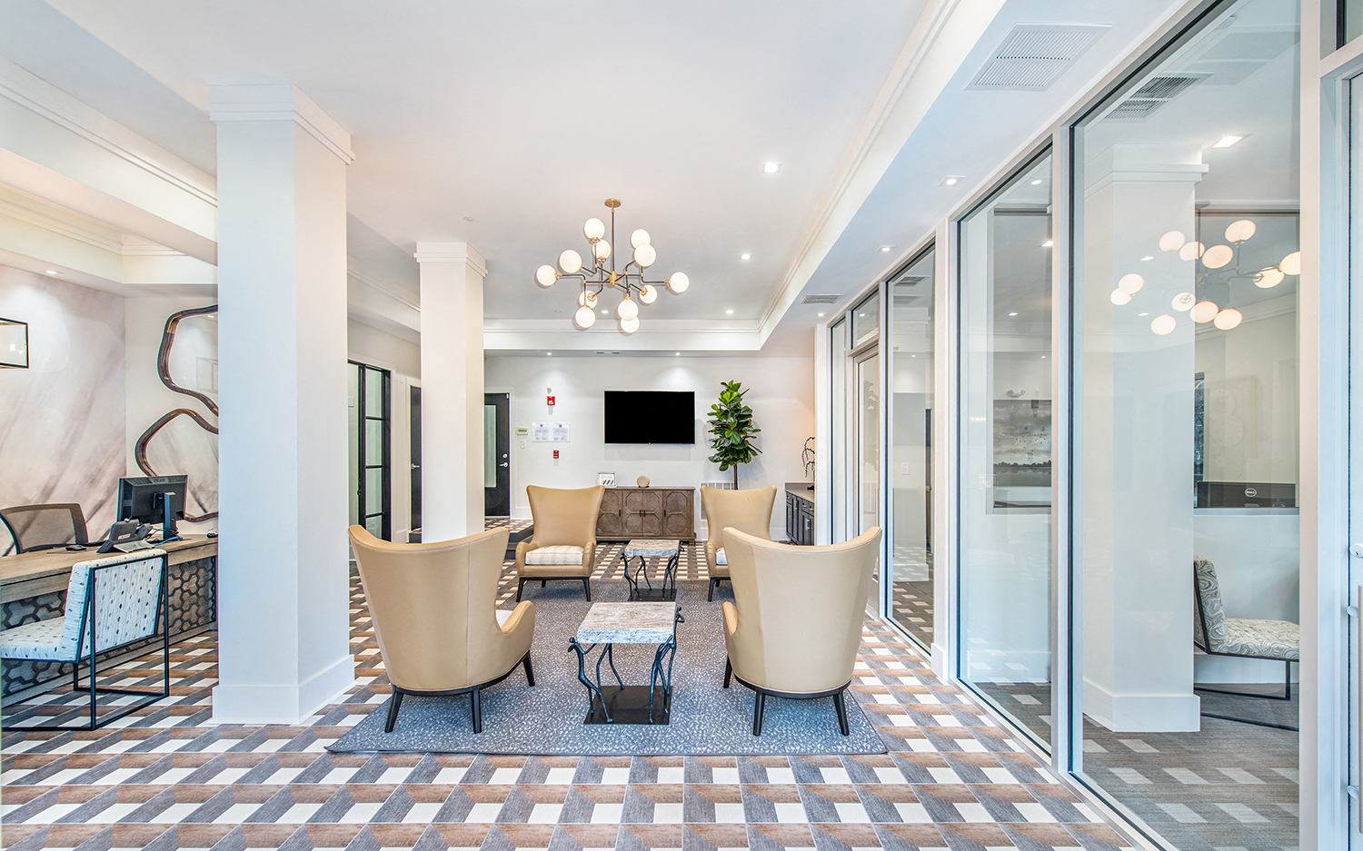 a living room with white pillars and glass doors