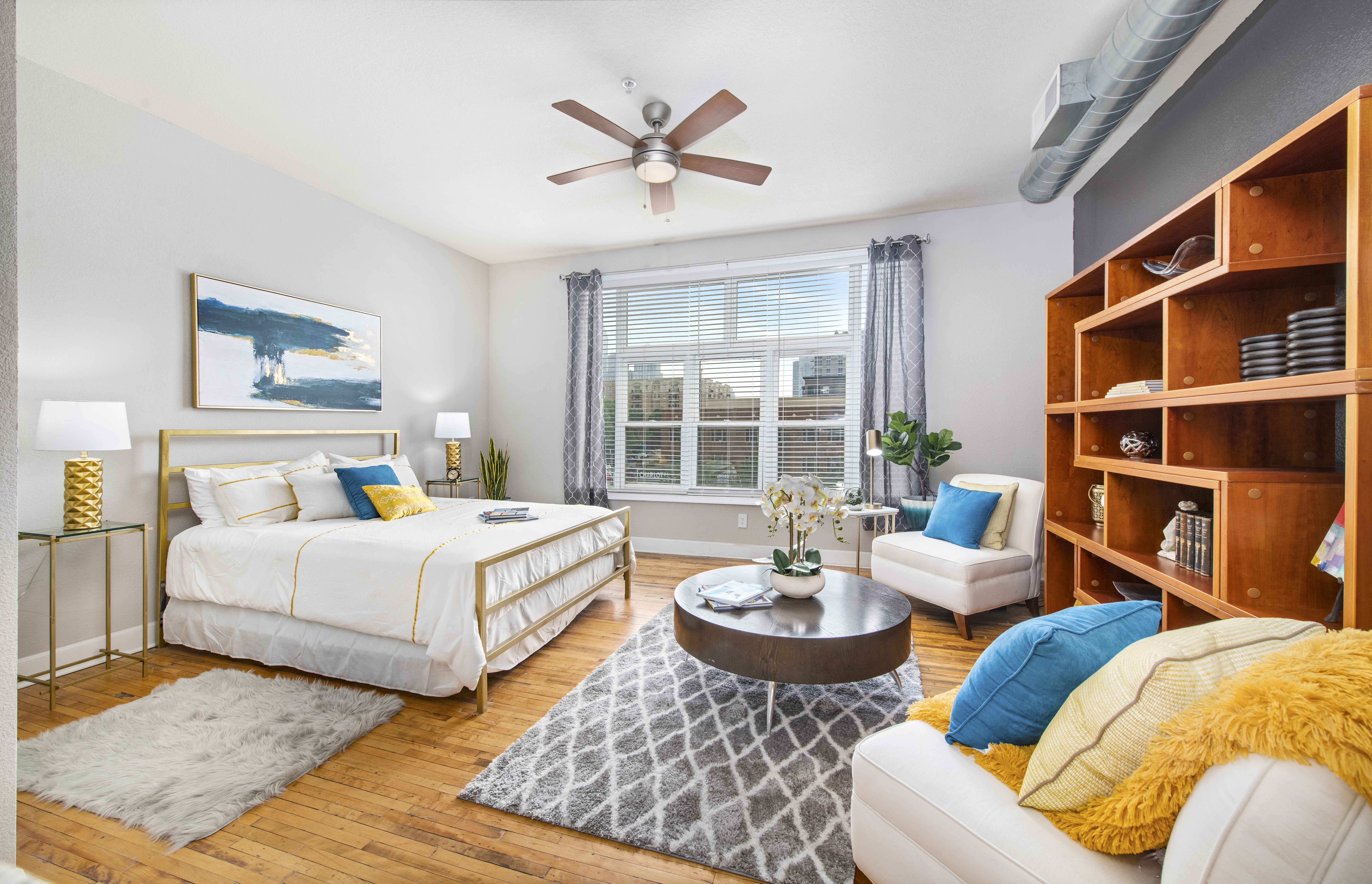 a bedroom with a bed and a ceiling fan