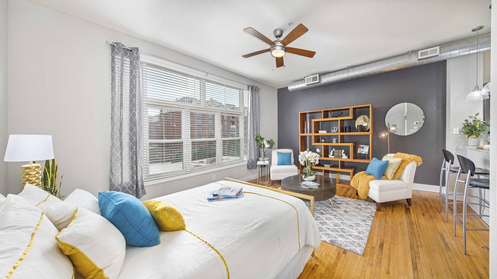 a bedroom with a large bed and a ceiling fan