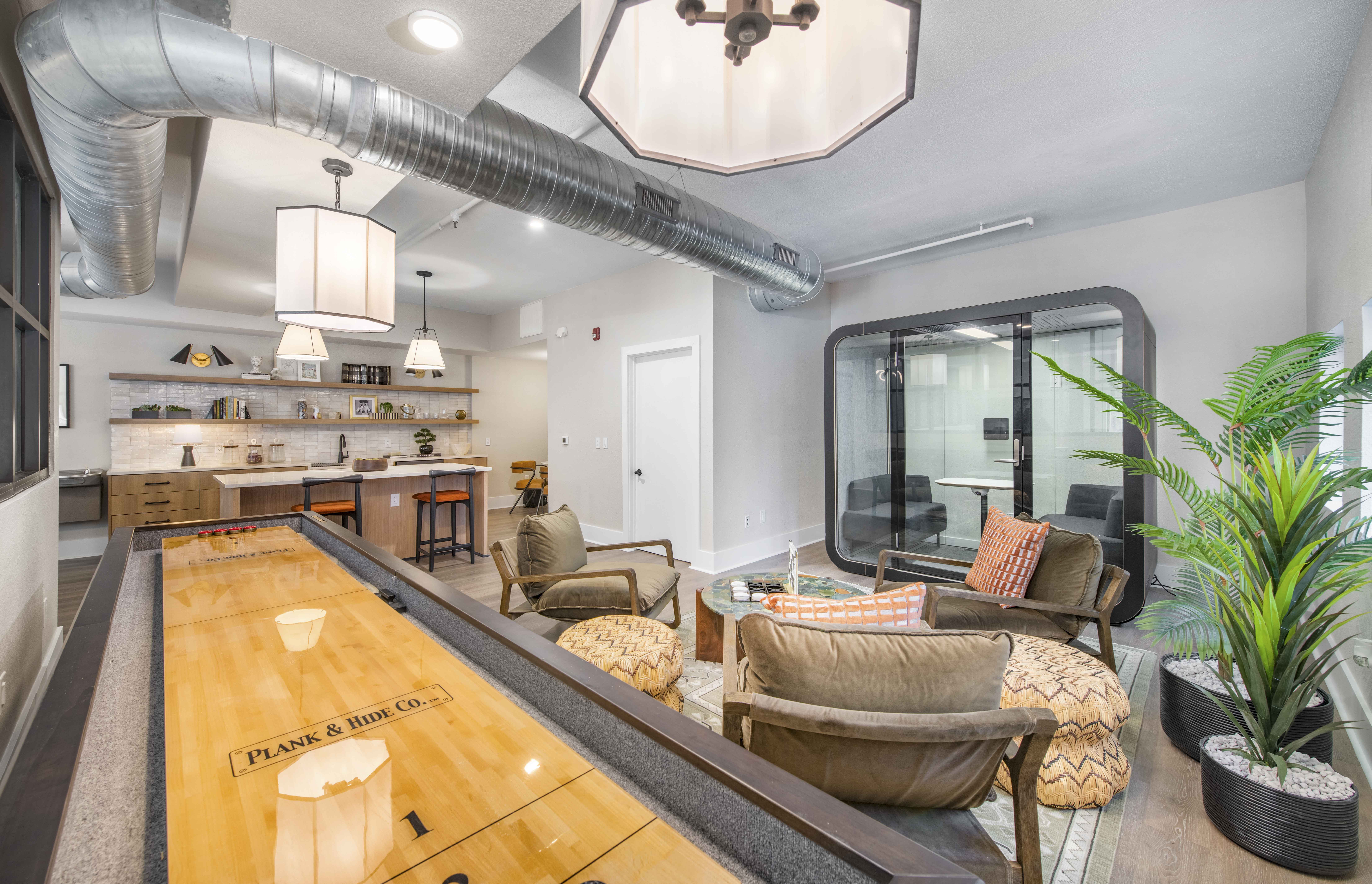 a living room with furniture and a bar and a kitchen