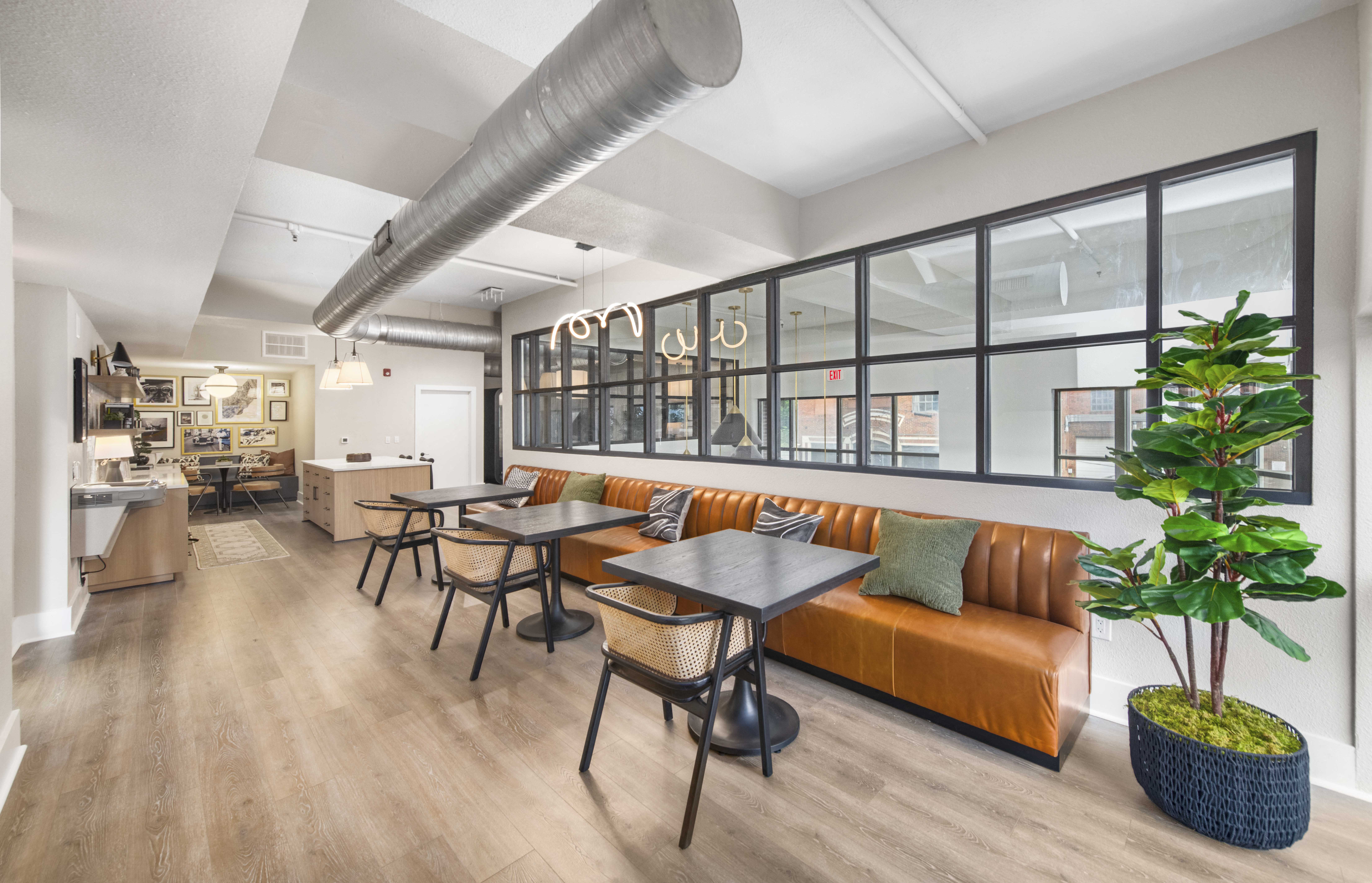a living room with a couch and tables in front of a window