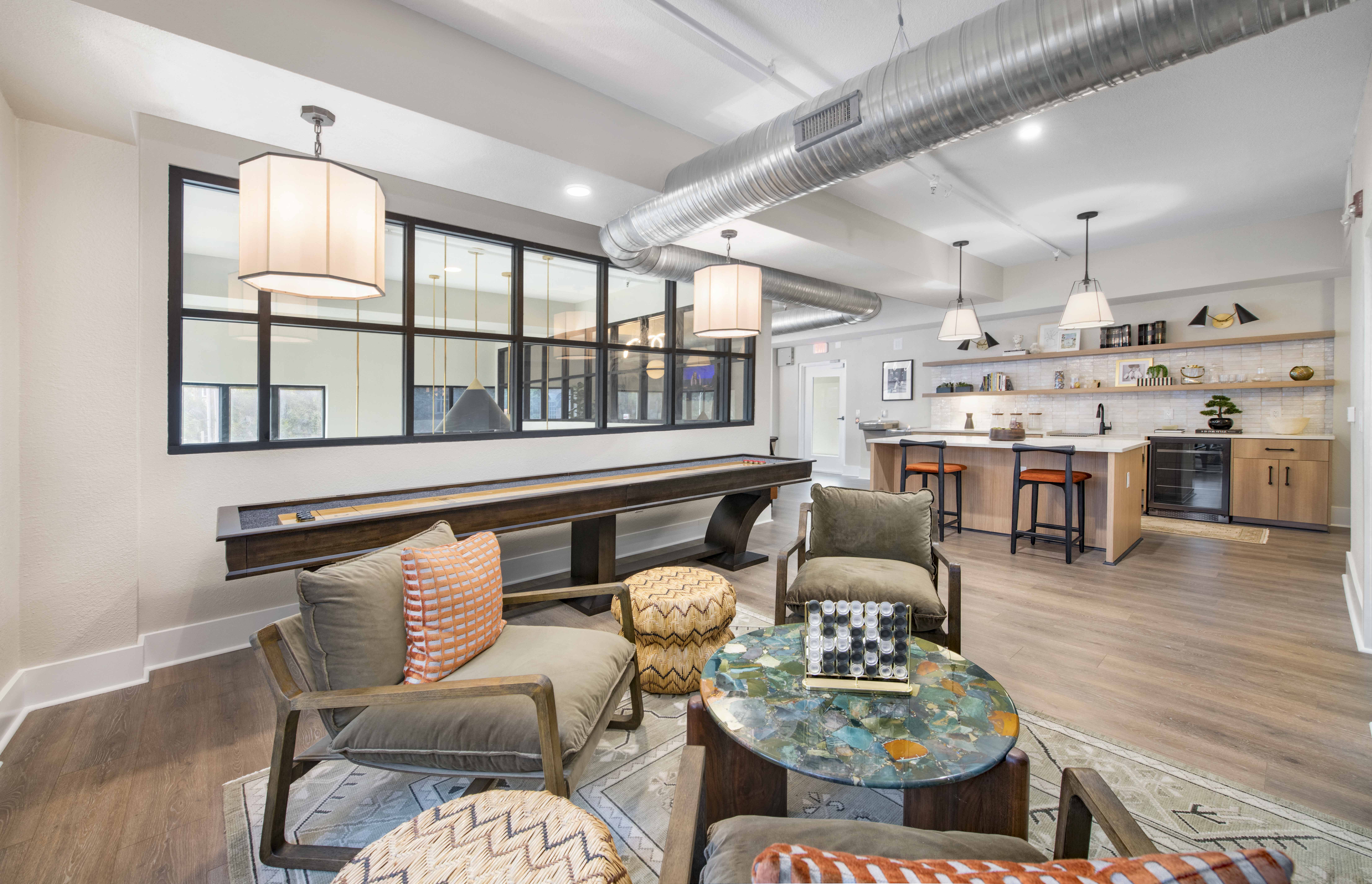 a living room with a bar and a dining room