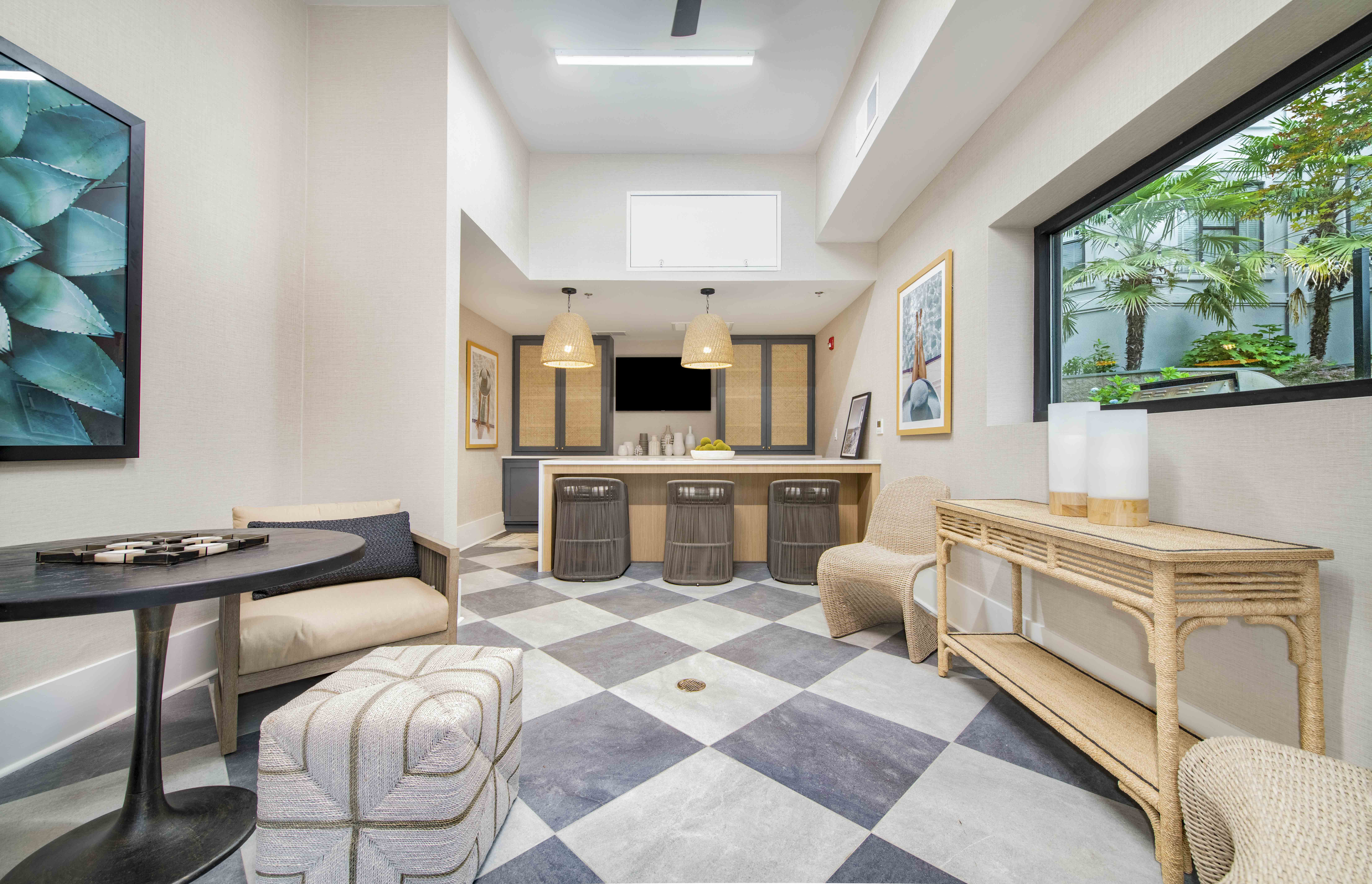 a living room and kitchen with a checkered floor