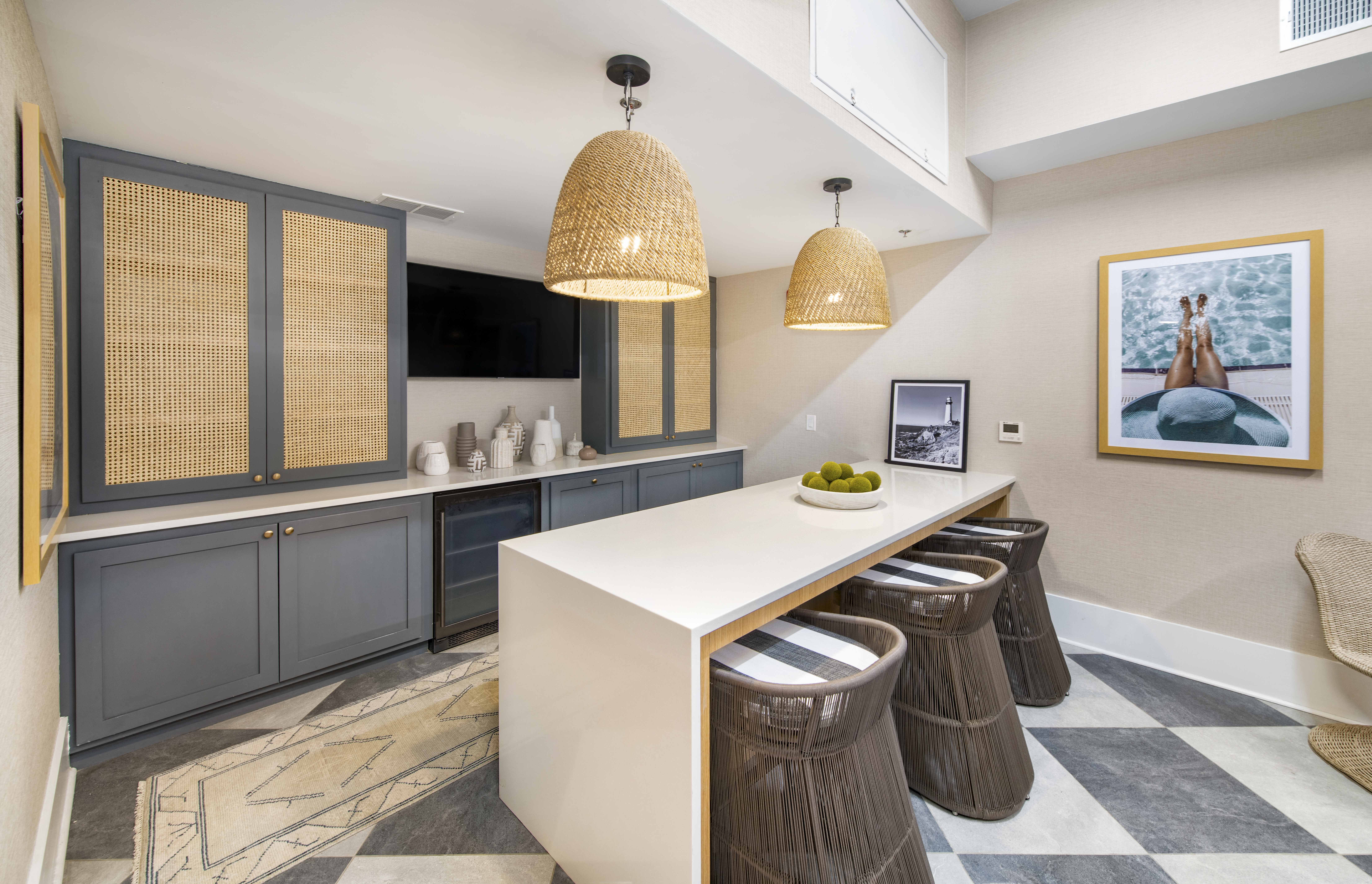 a kitchen with a long counter top and stools