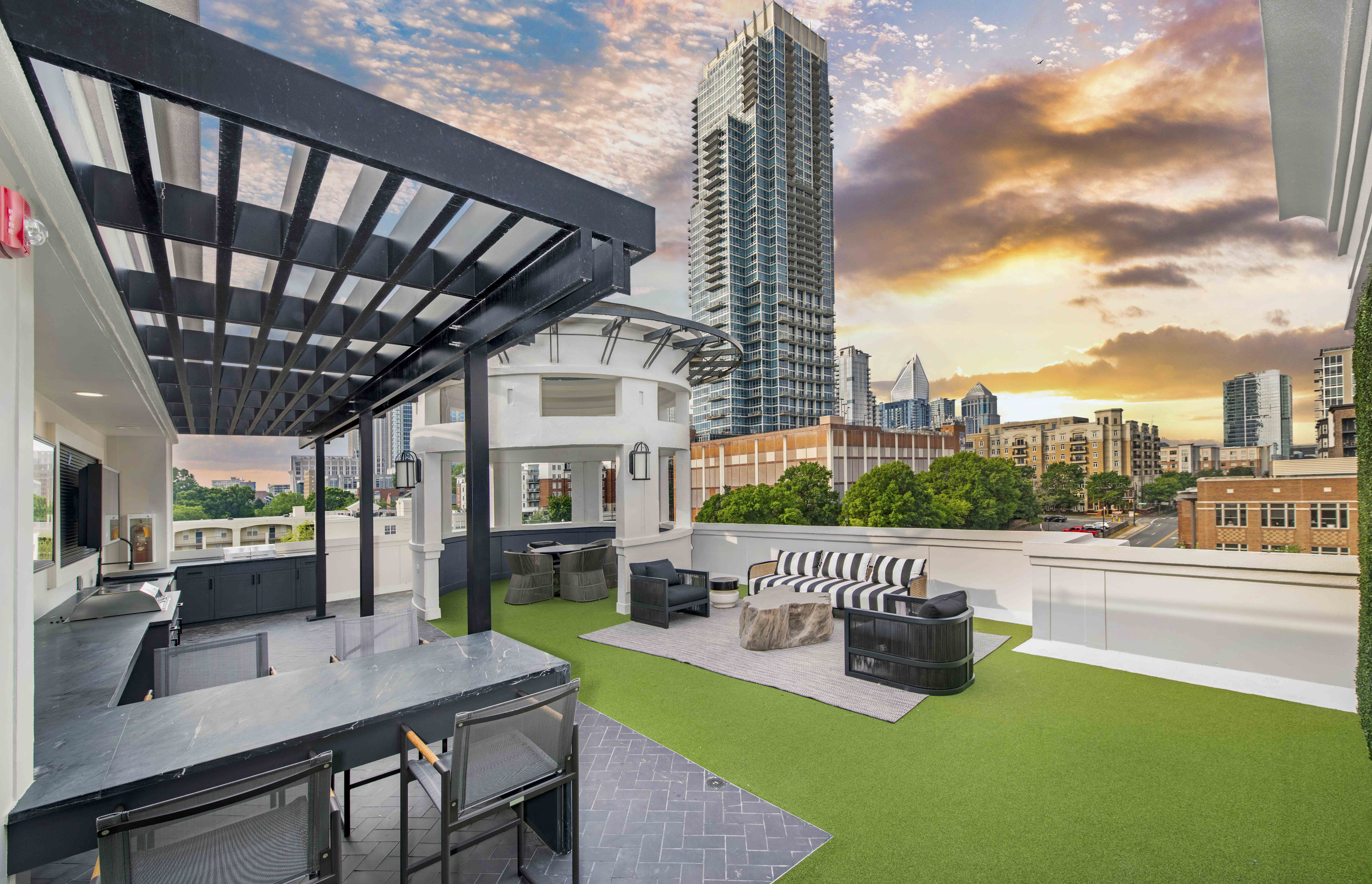 a rooftop patio with a city skyline in the background