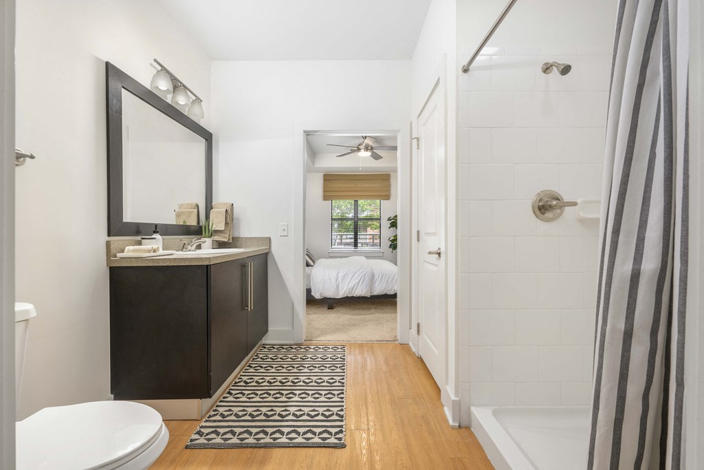 a bathroom with a shower and a sink and a toilet