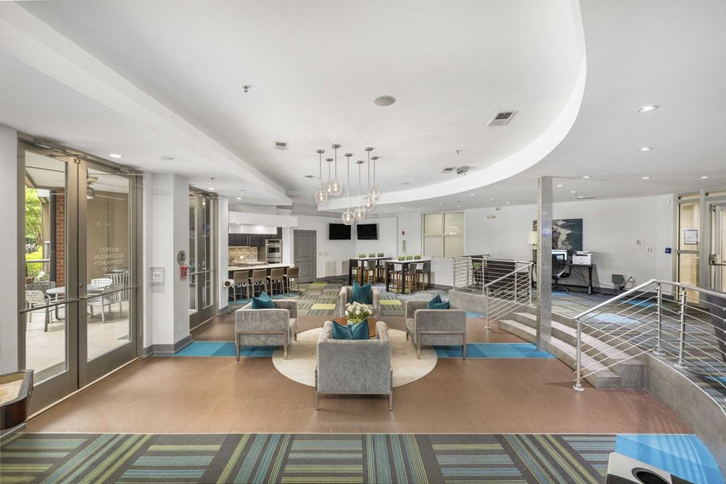 a lobby with couches and chairs and a staircase