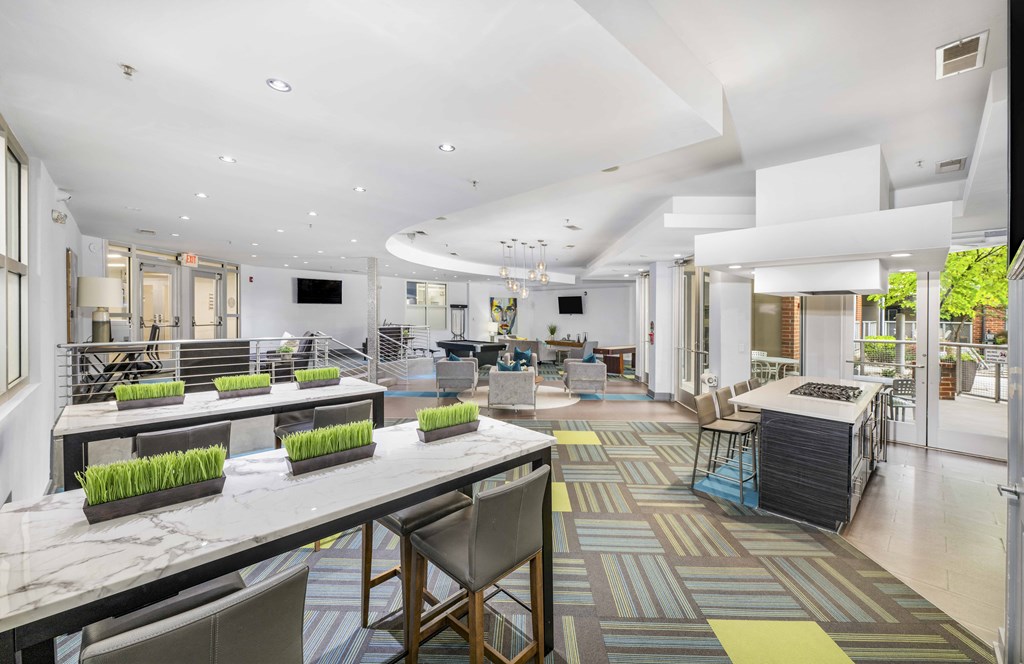 a communal area with tables and chairs in a lobby