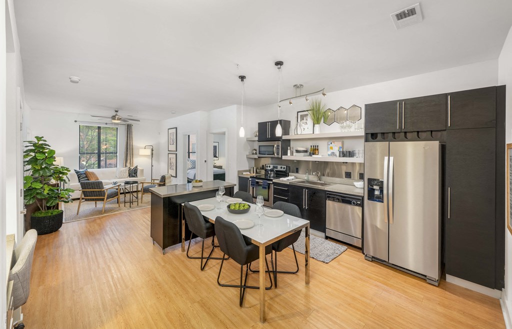 a kitchen with stainless steel appliances and a dining table