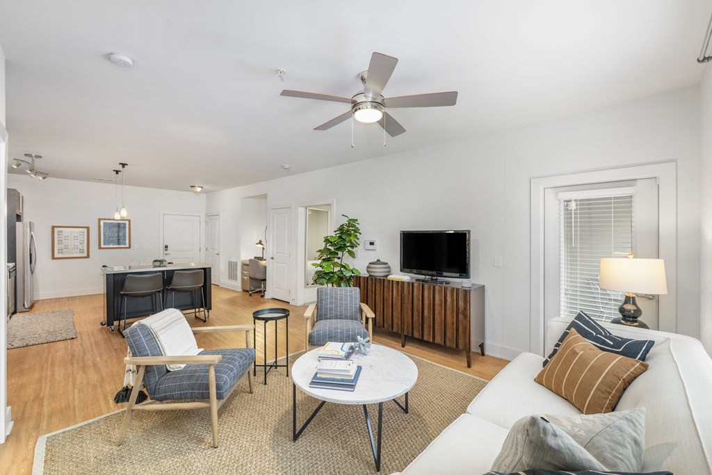 a living room with furniture and a ceiling fan