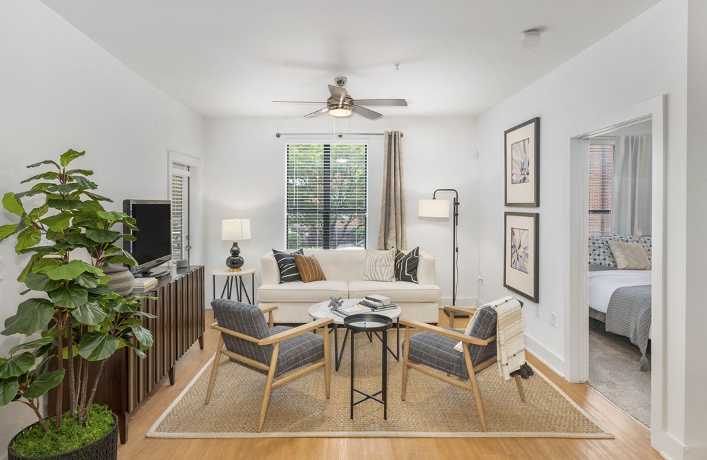a living room with a couch and a table and a ceiling fan