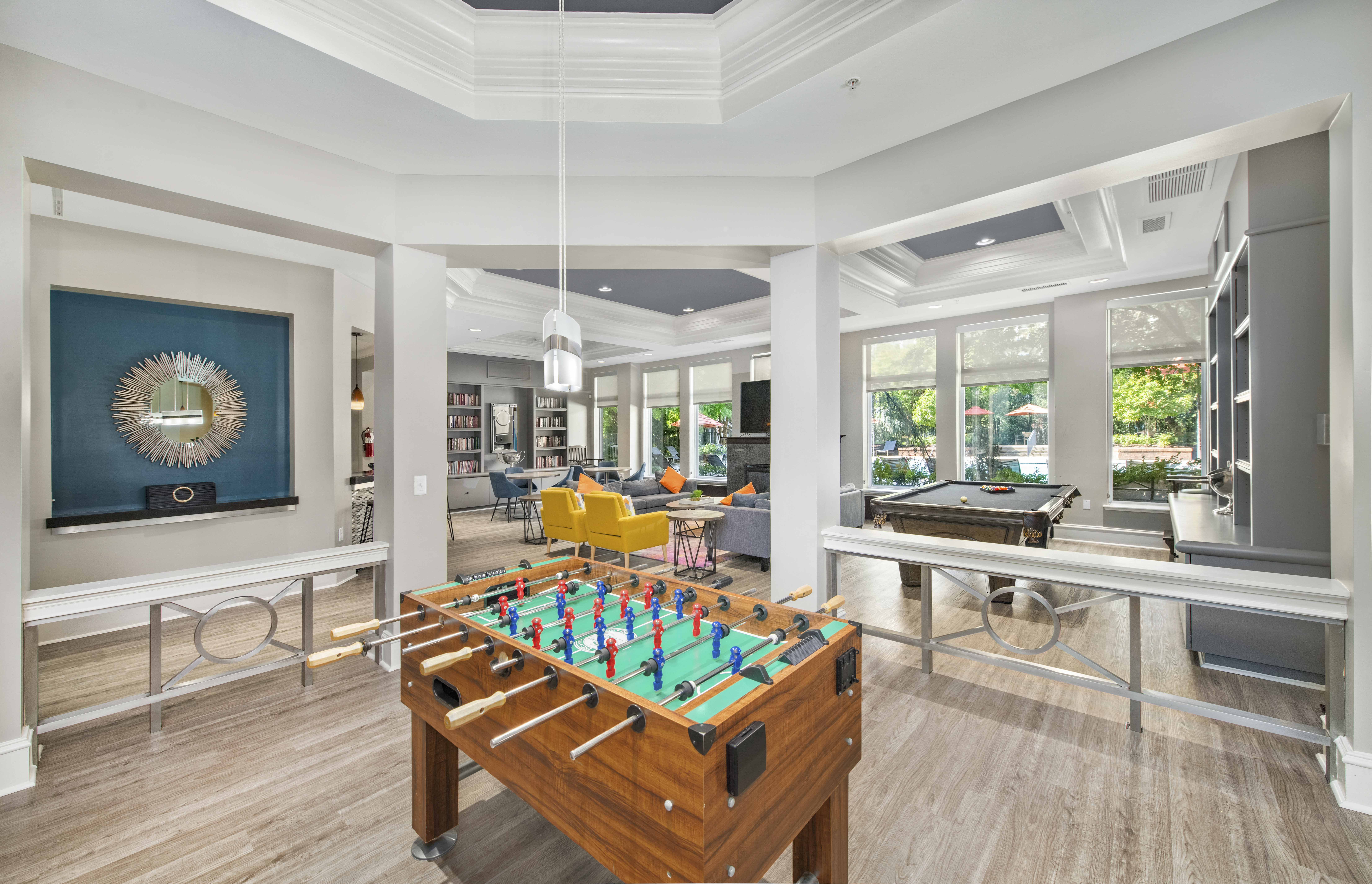 a game room with a foosball table and a pool table