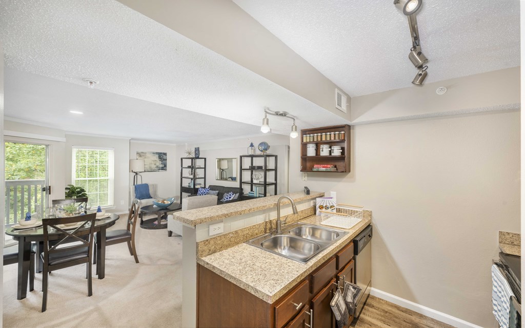 A kitchen with a sink and a dining table.