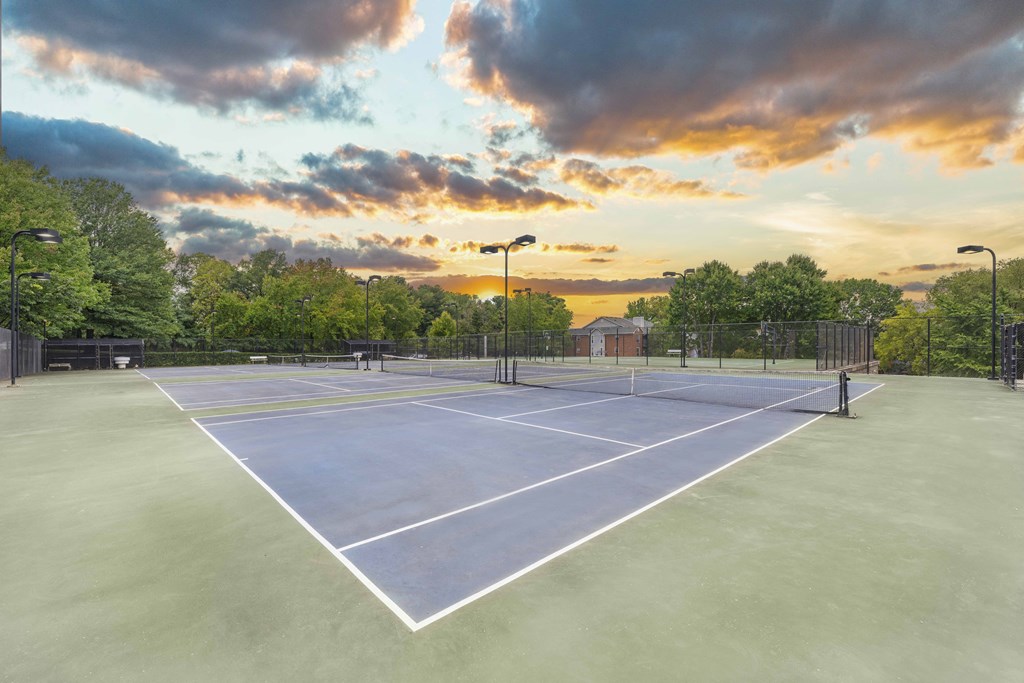 A tennis court with a net and two players ready to play.