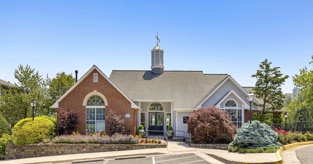 A church with a steeple and a cross on top of it.