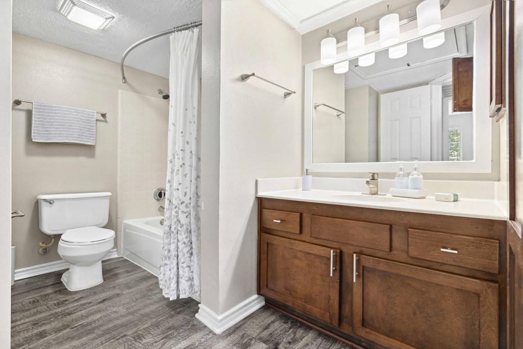 A bathroom with a toilet, sink, and shower.