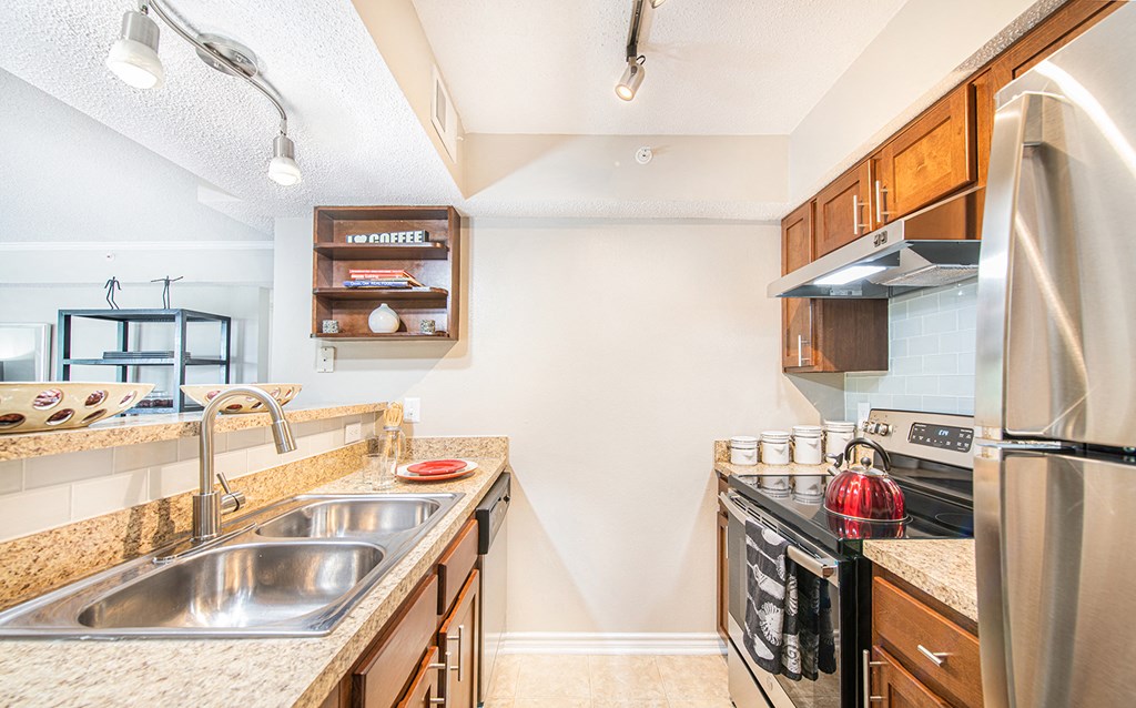 a kitchen with stainless steel appliances and granite counter tops