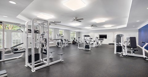 A spacious gym with various exercise equipment.
