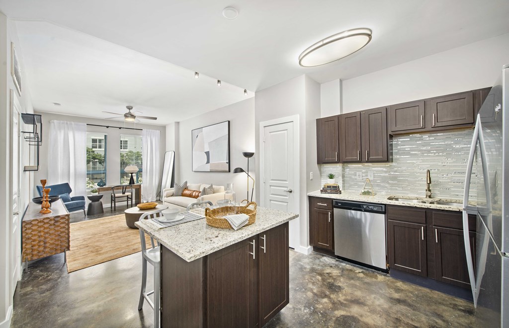 a kitchen with a island and a living room