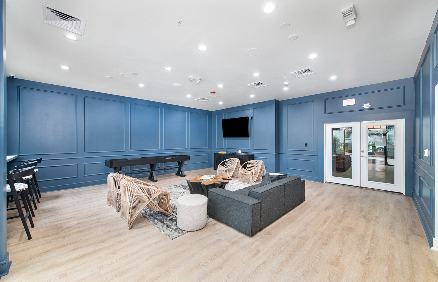 a living room with blue walls and a couch and a piano
