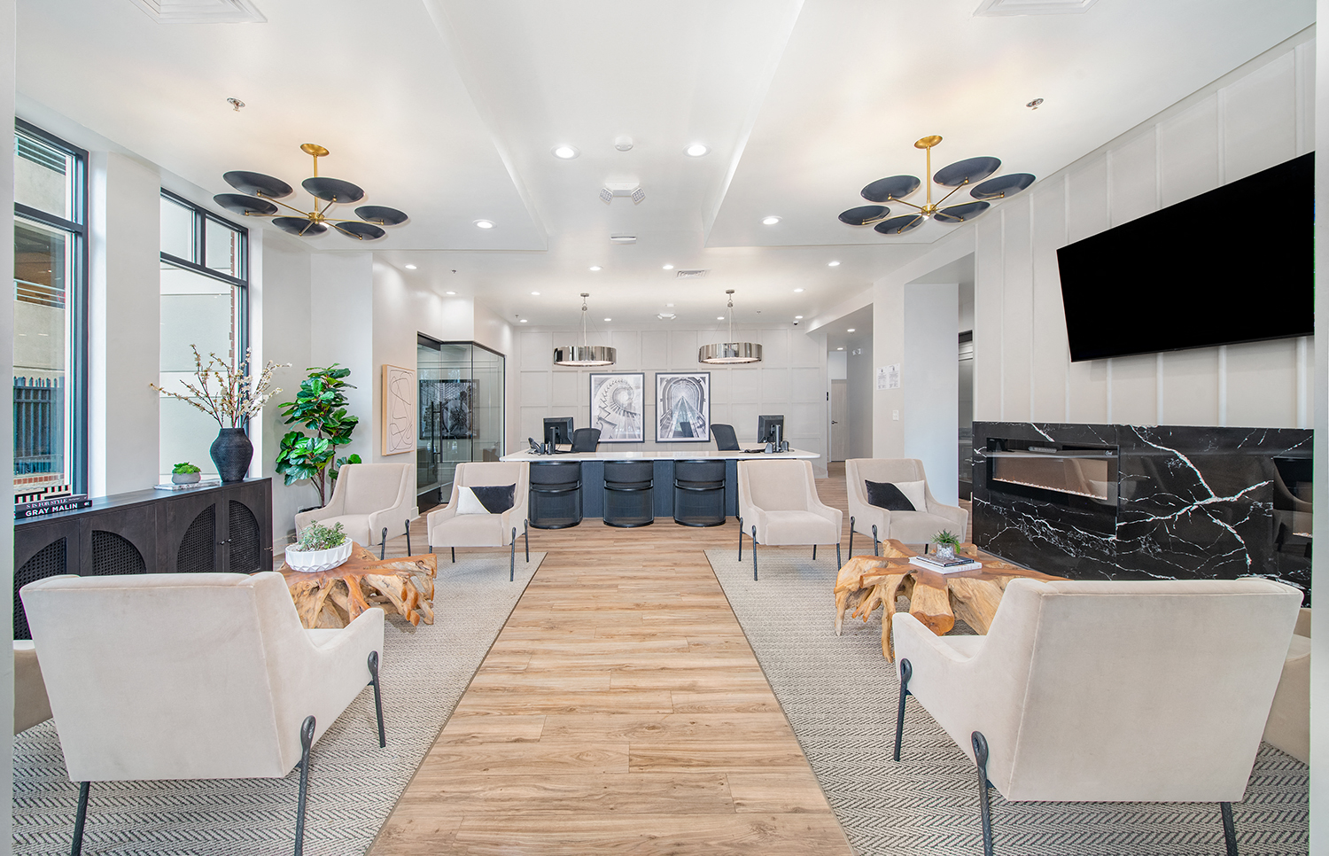 a living room with white chairs and a table and a fireplace