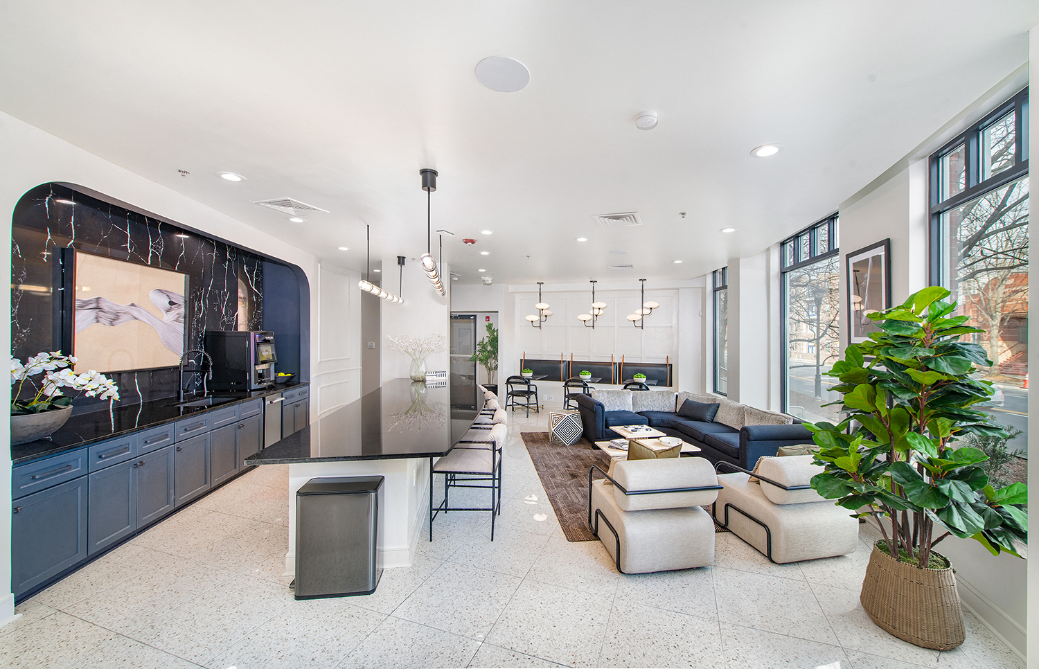 the living room has a large screen tv and a bar with couches and chairs