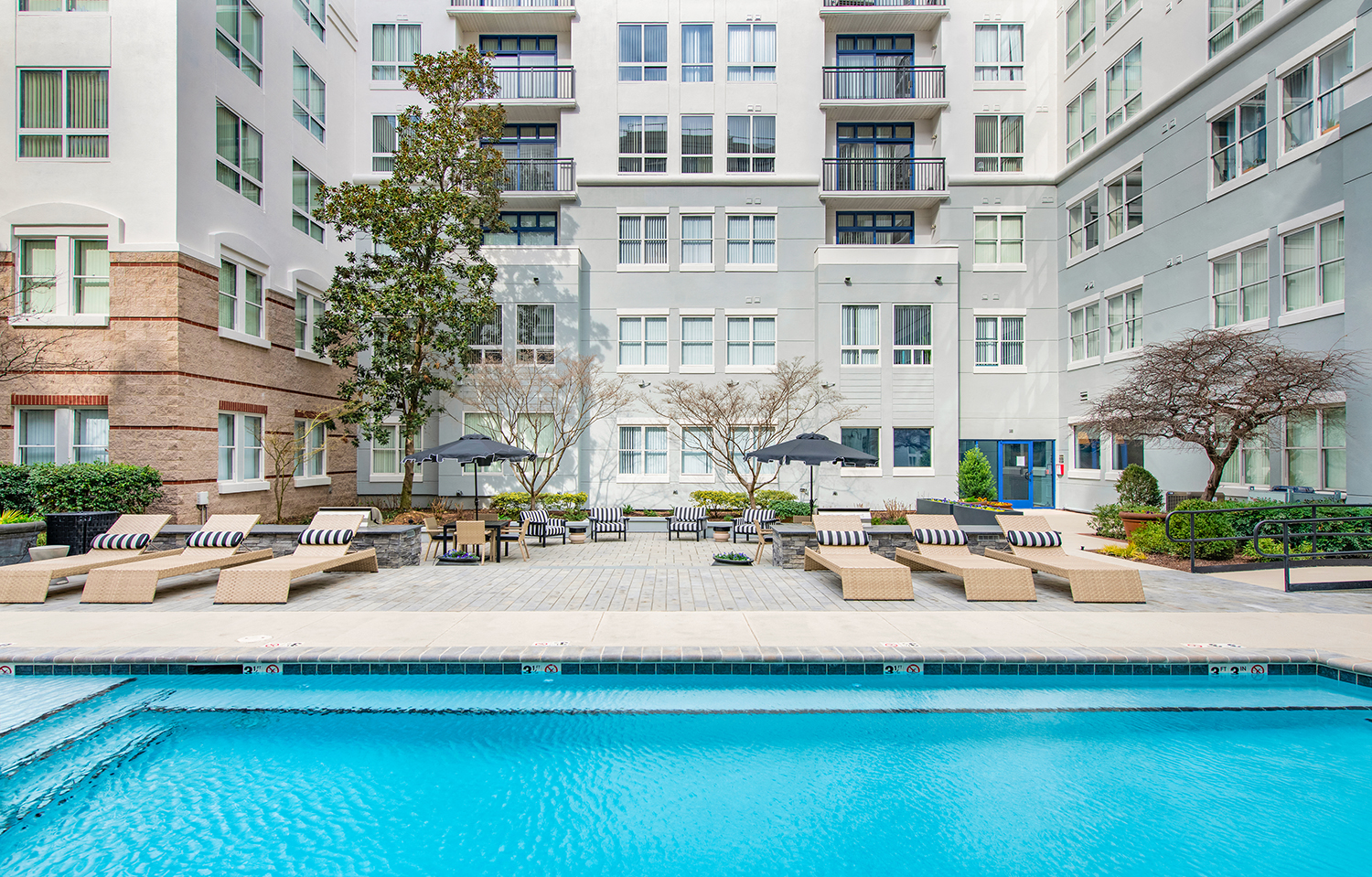 a swimming pool in front of an apartment building