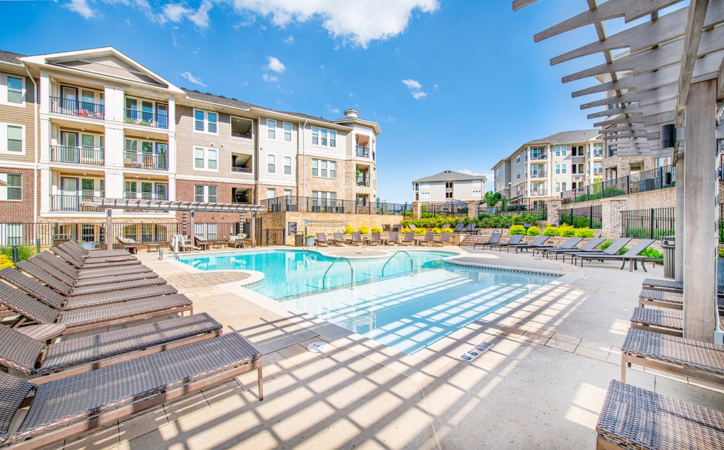 our apartments have a large pool and lounge chairs in front of our building