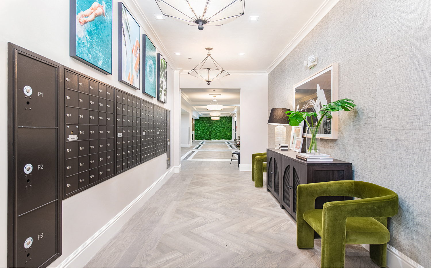 a long hallway with lockers and green chairs and a plant