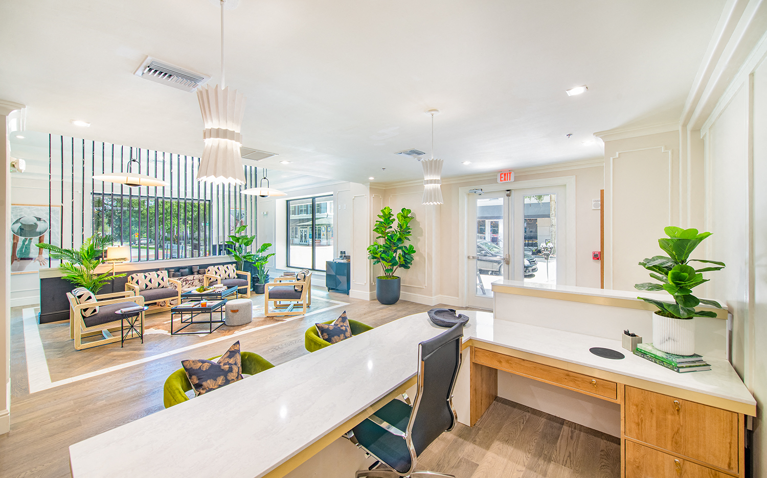 the lobby of a building with a reception desk and a seating area