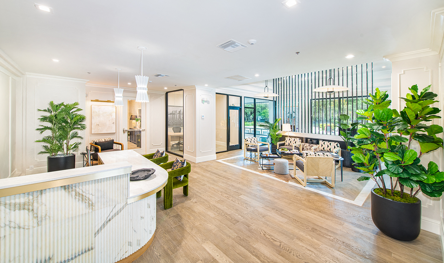 the living room and dining area of a house with large potted plants