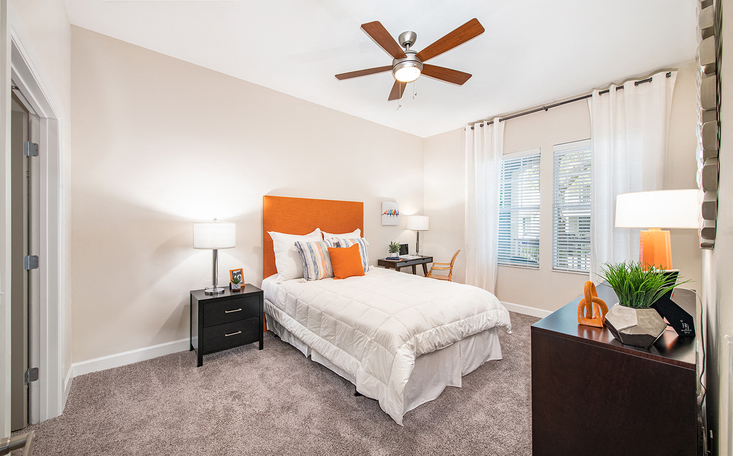 a bedroom with a bed and a ceiling fan