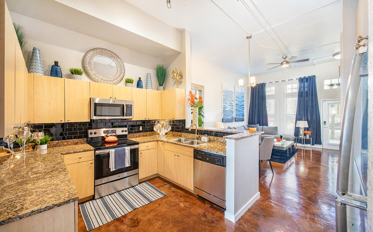 a kitchen with granite counter tops and stainless steel appliances