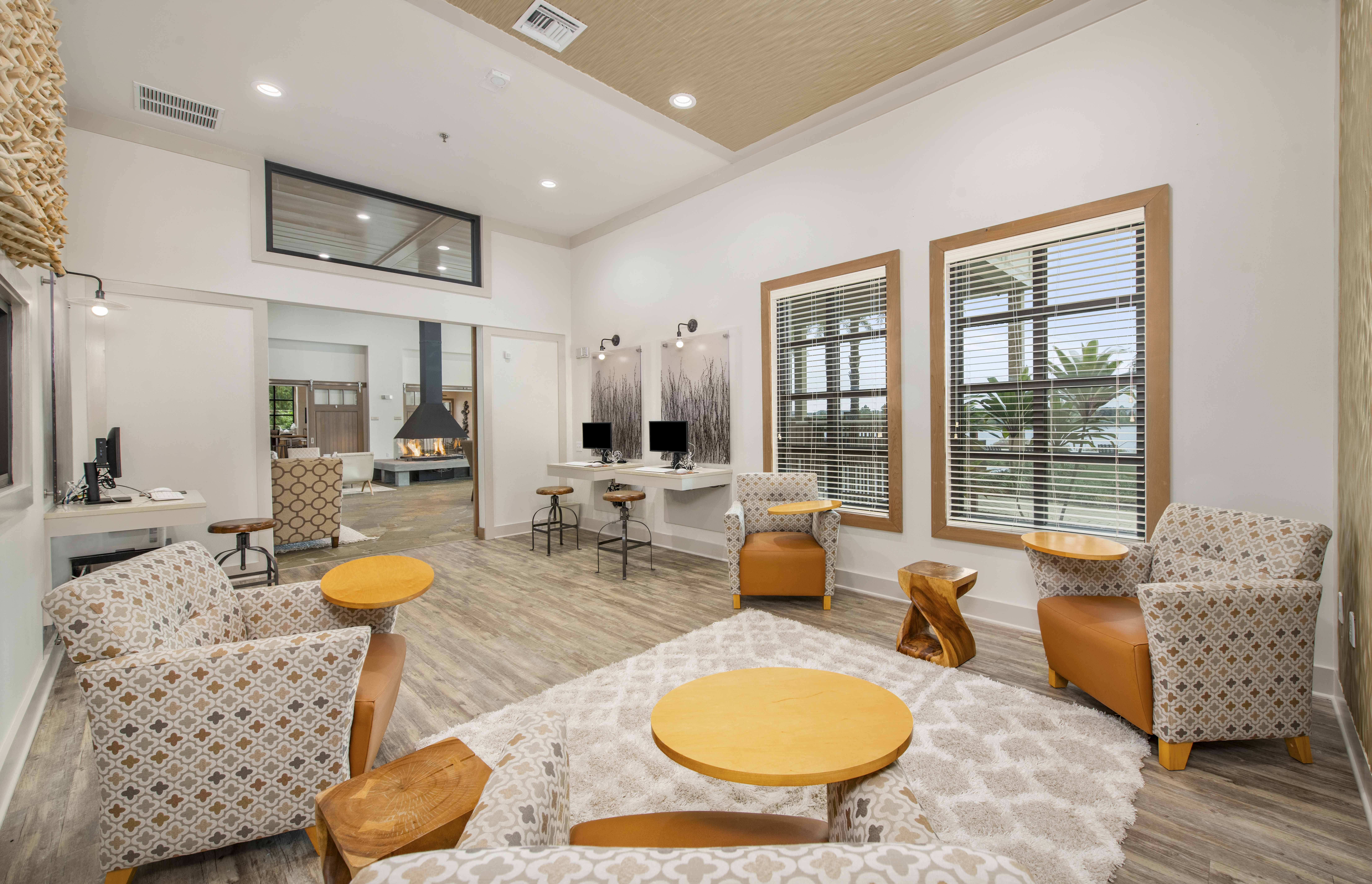 a living room with chairs and a table