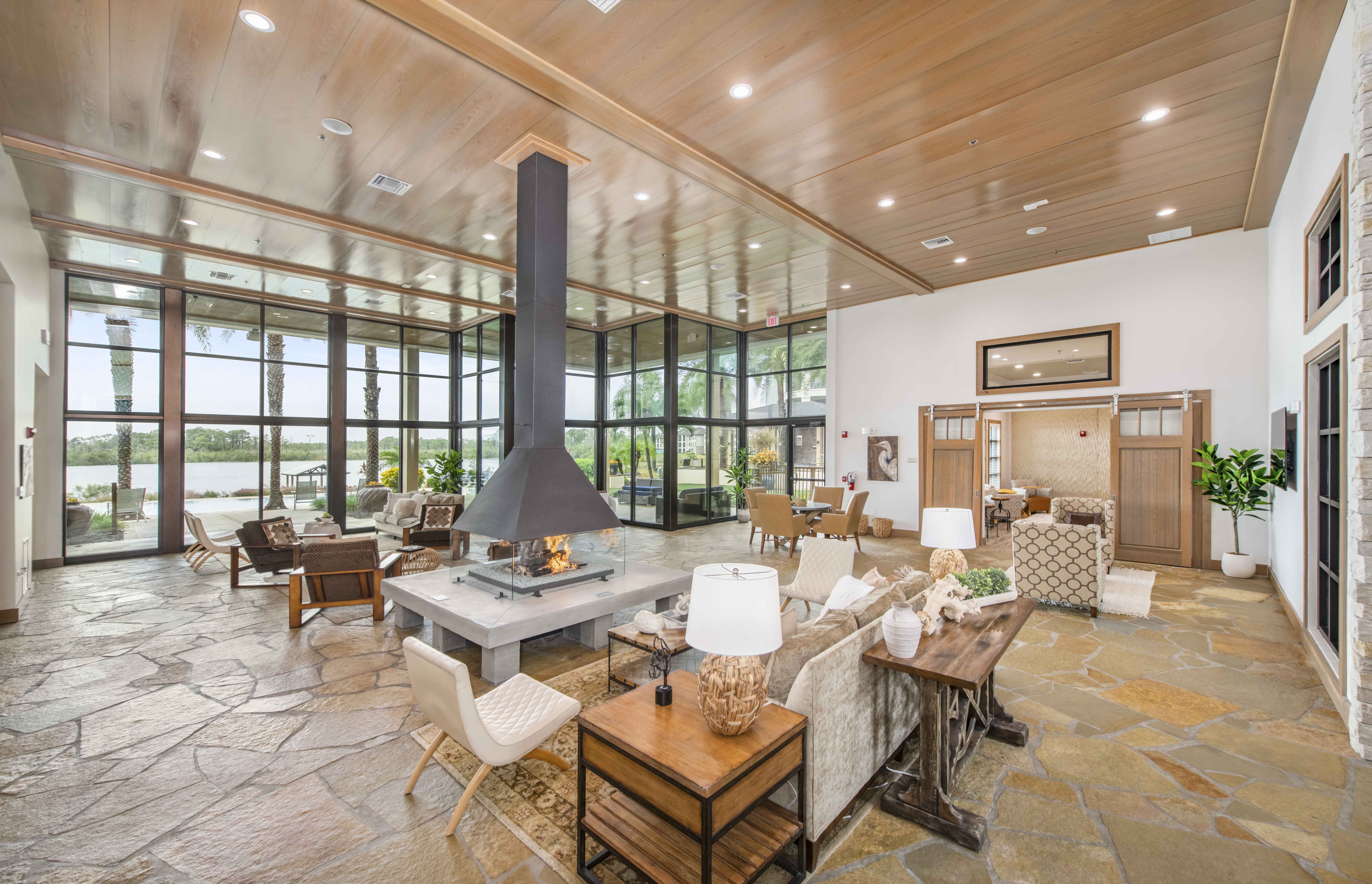 a large living room with a large fireplace and a large table and chairs