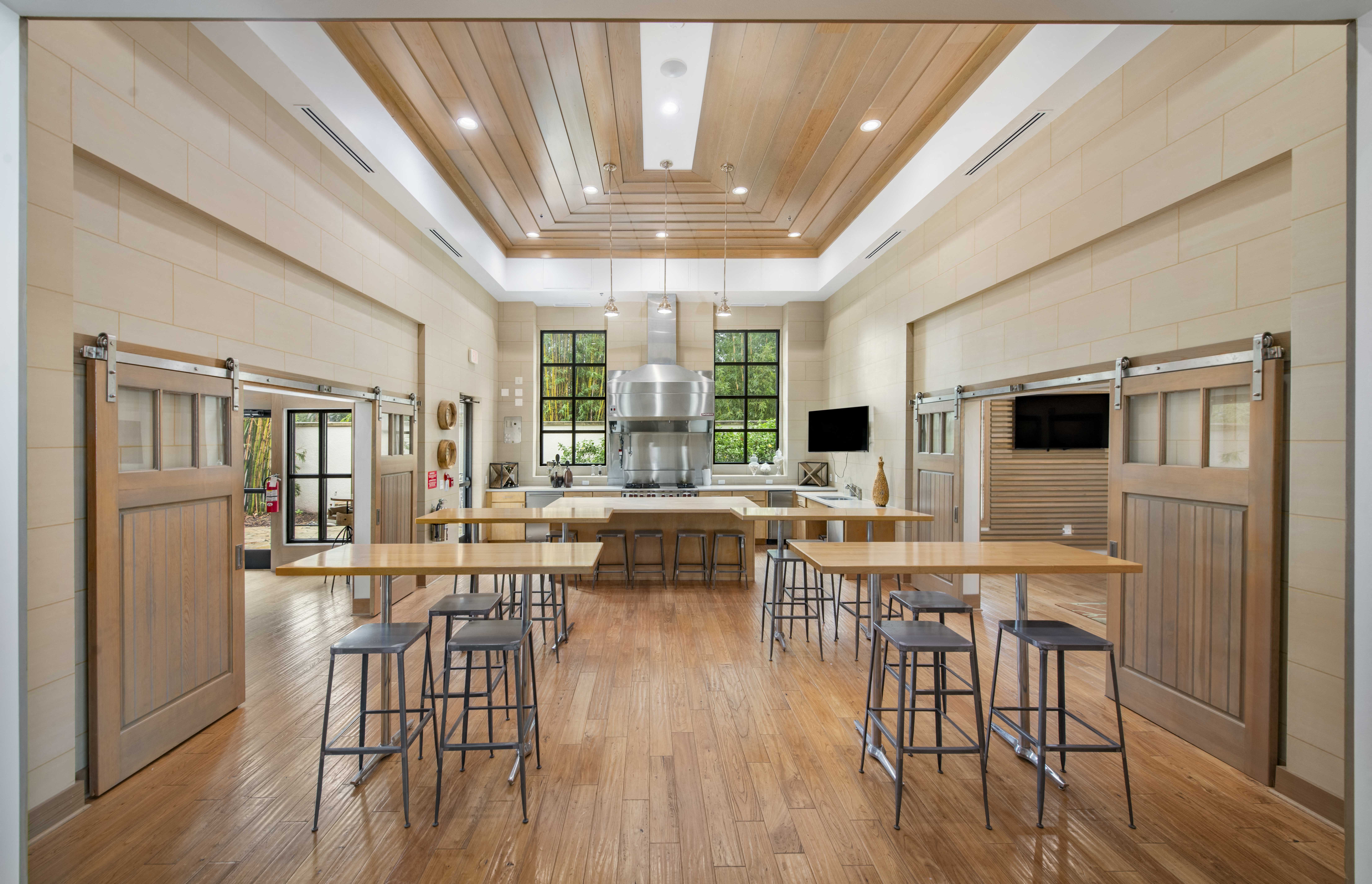 a large kitchen with wood floors and a large island with chairs