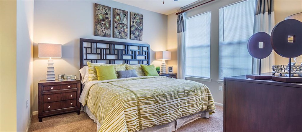 a bedroom with a bed and a large window