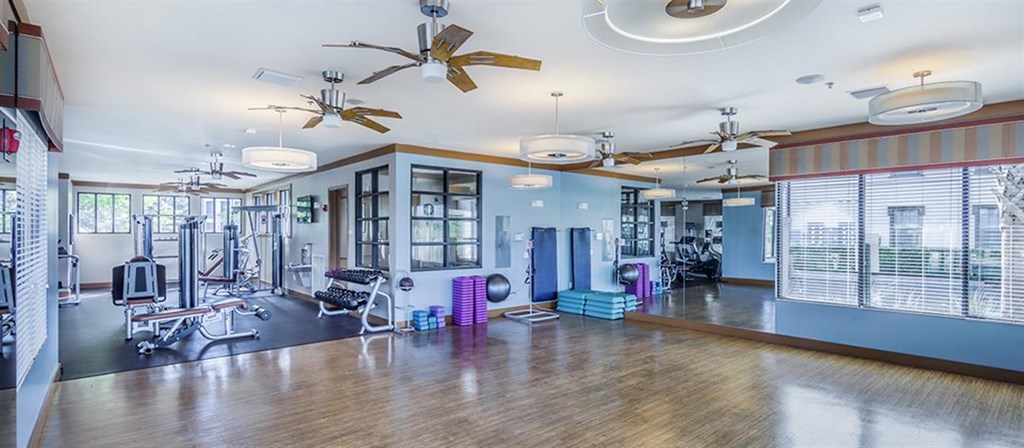 a fitness room with weights and exercise equipment in a building