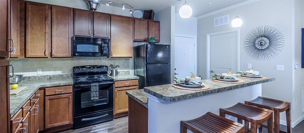 a kitchen with a counter top and a black stove