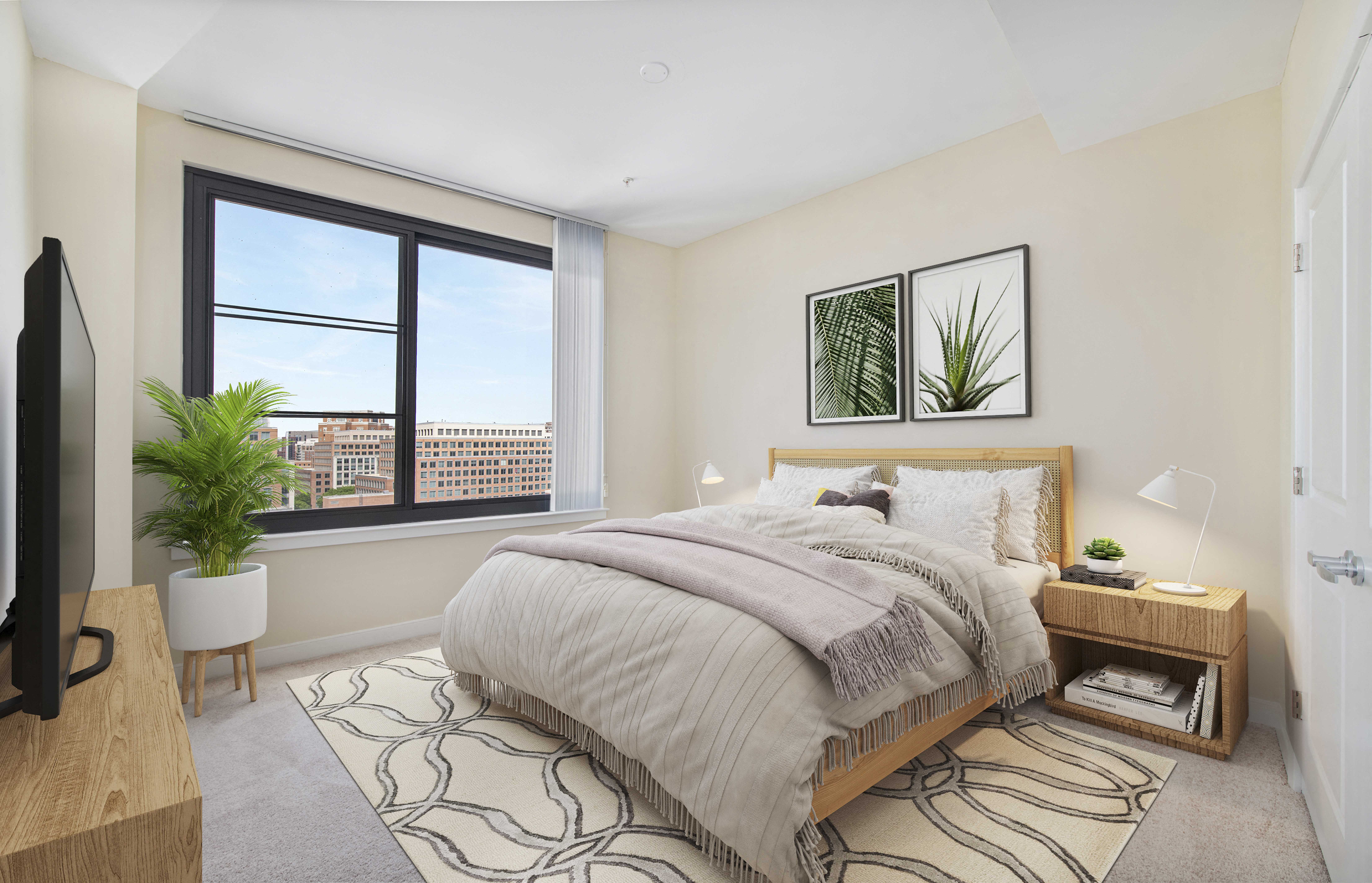 a bedroom with a large window and a bed