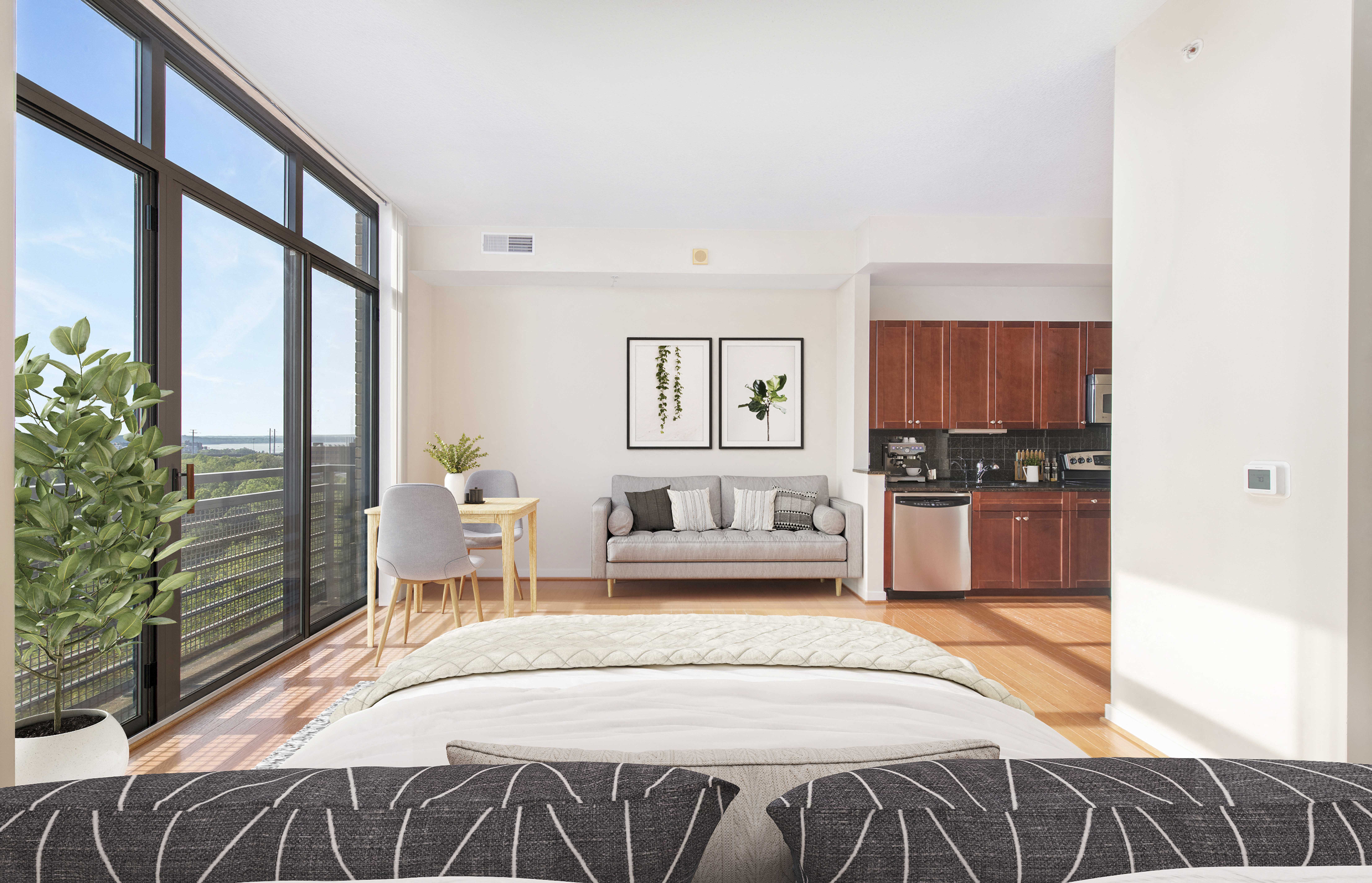 a bedroom with a bed and a living room with a kitchen