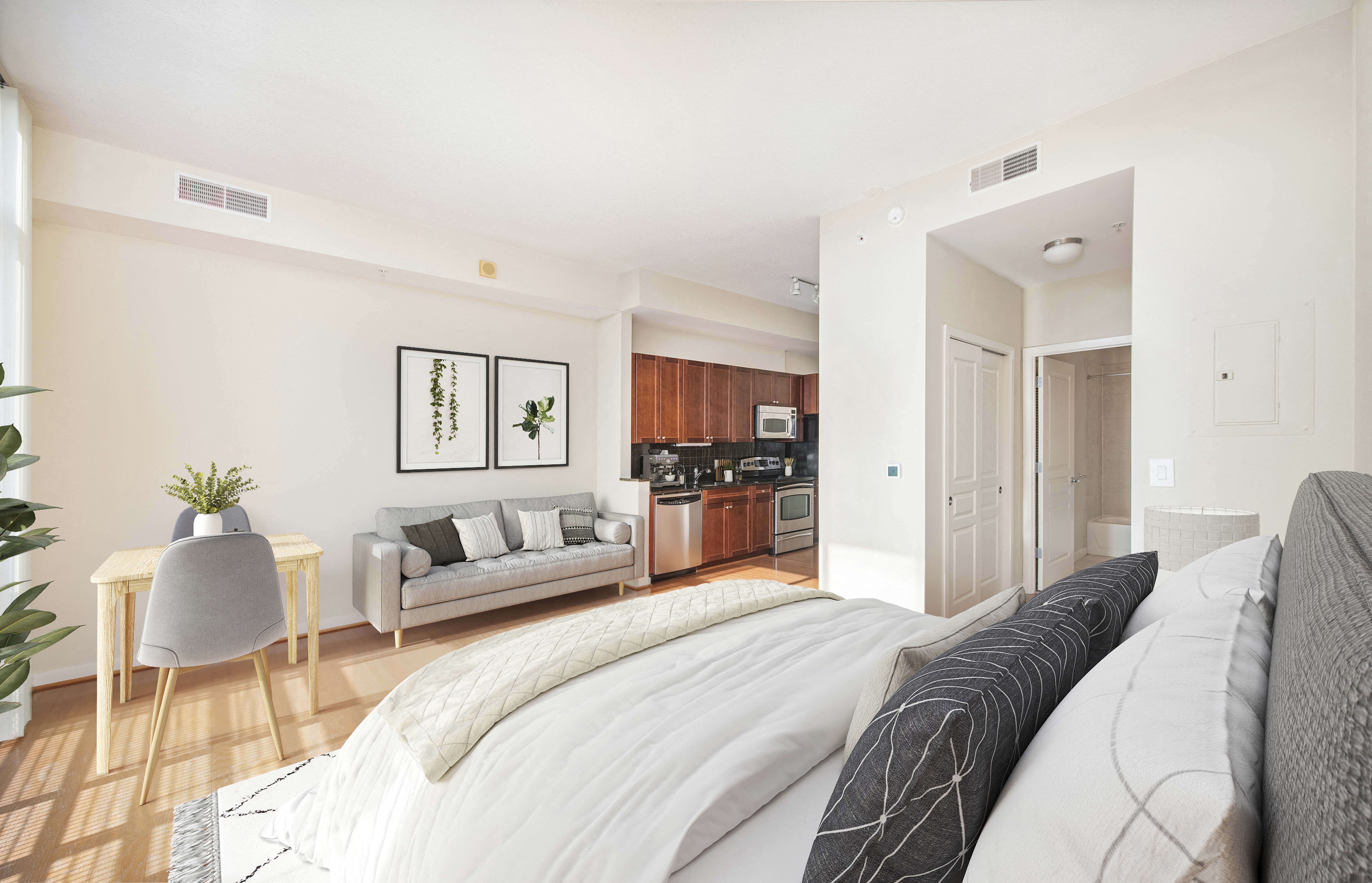 a bedroom with a bed and a living room