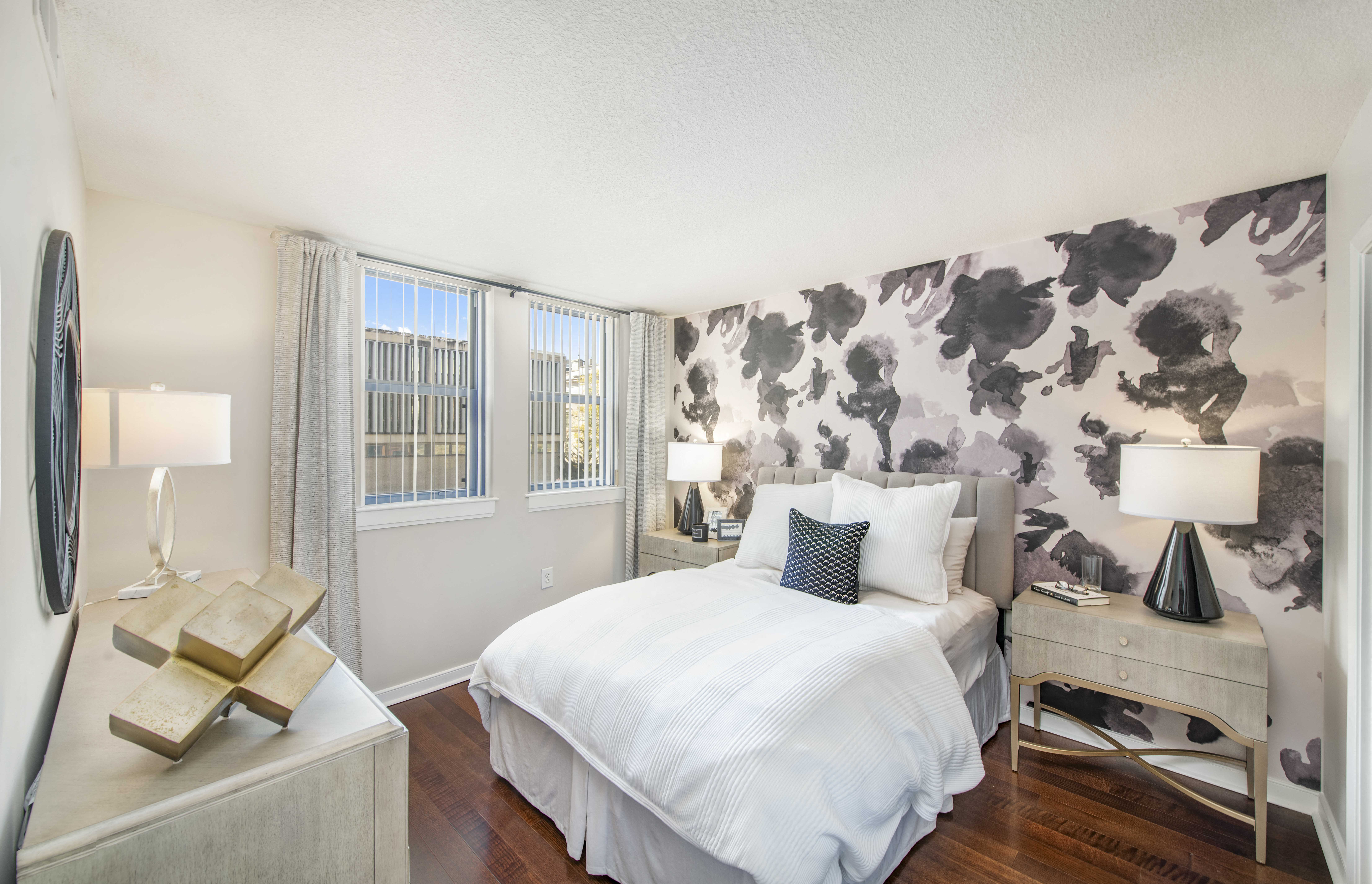 a bedroom with a large bed and a wallpaper on the wall