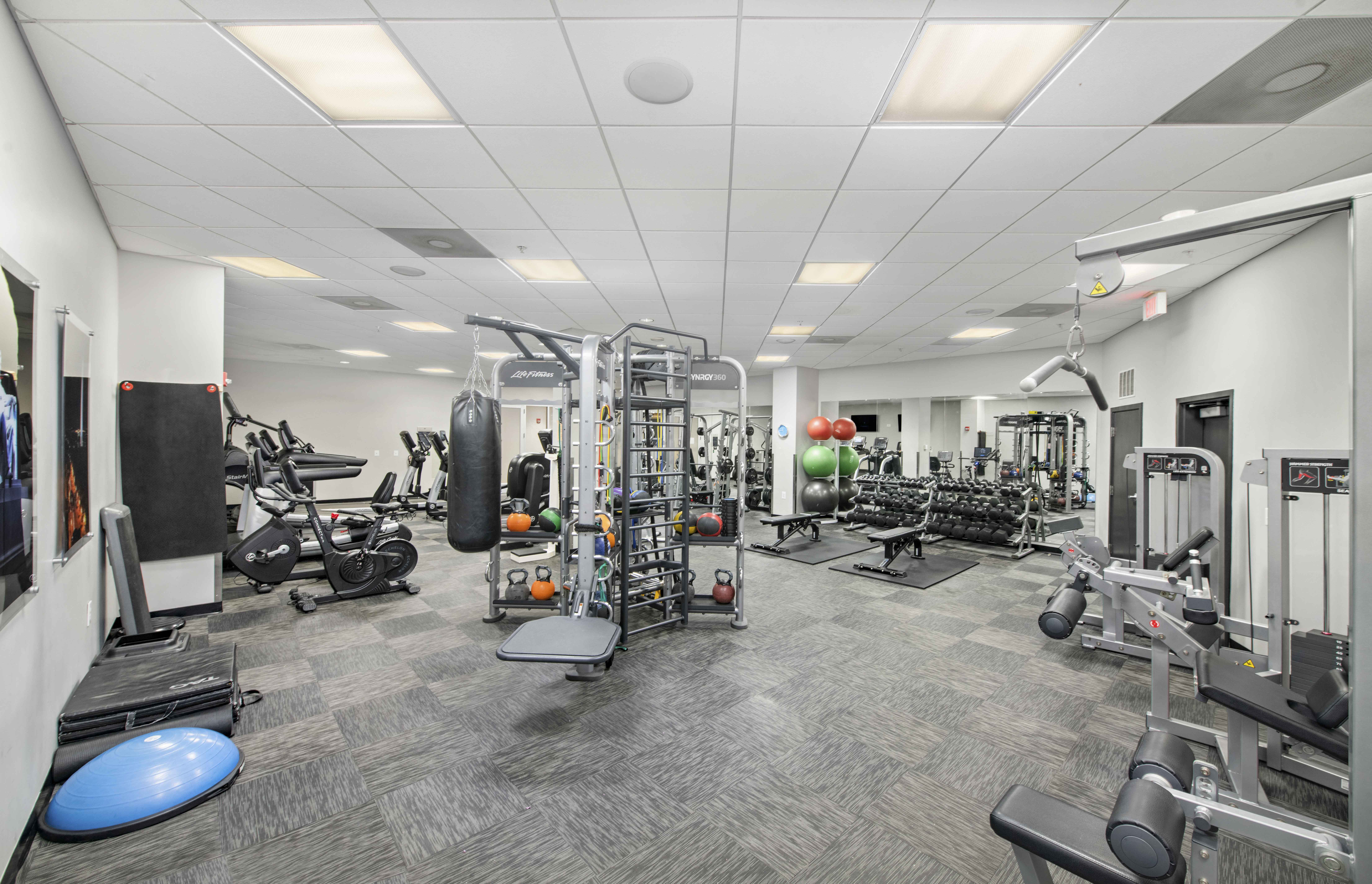 the gym is equipped with weights and cardio equipment at the belgard apartments