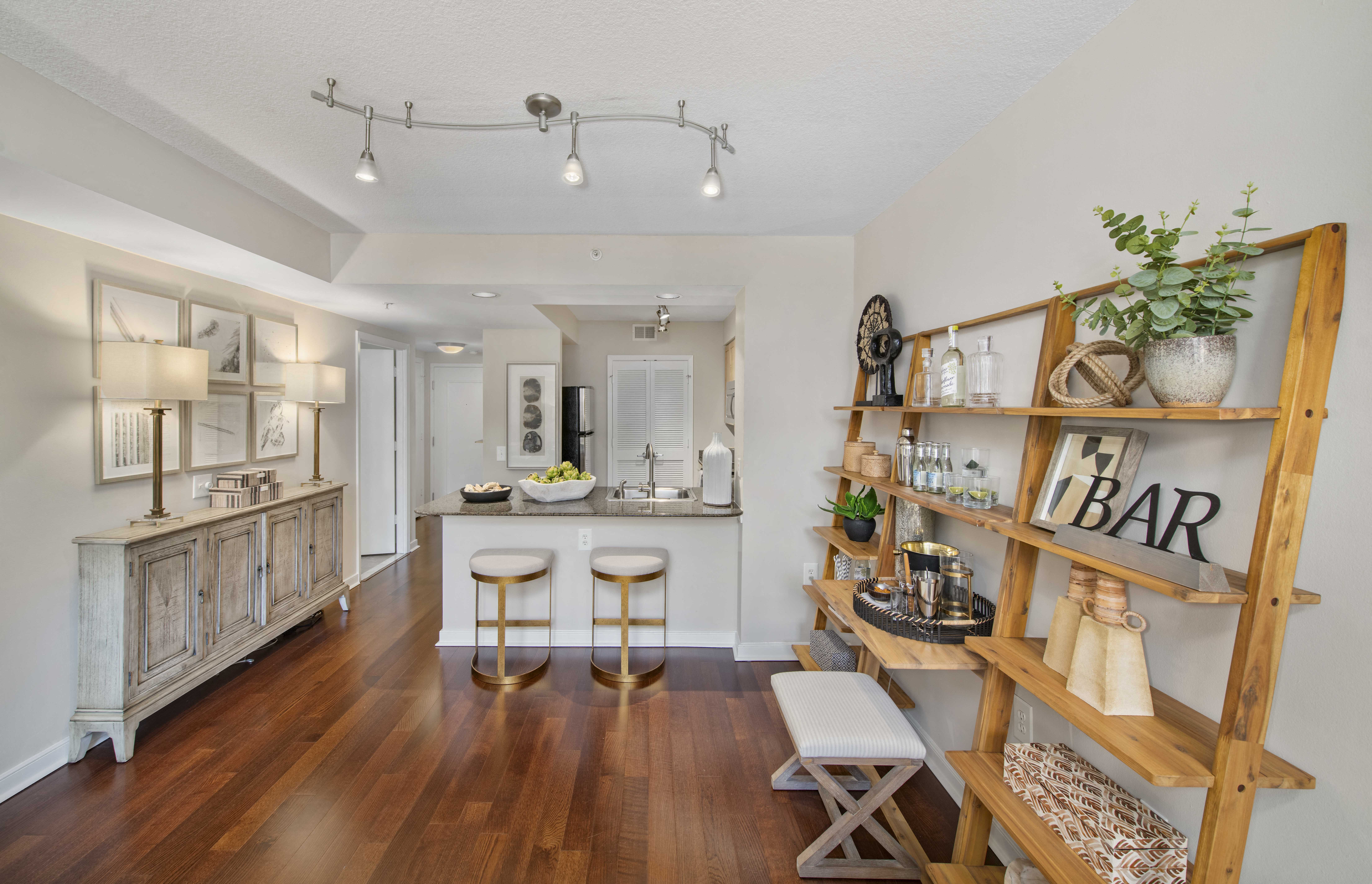 a living room with a bar and a kitchen