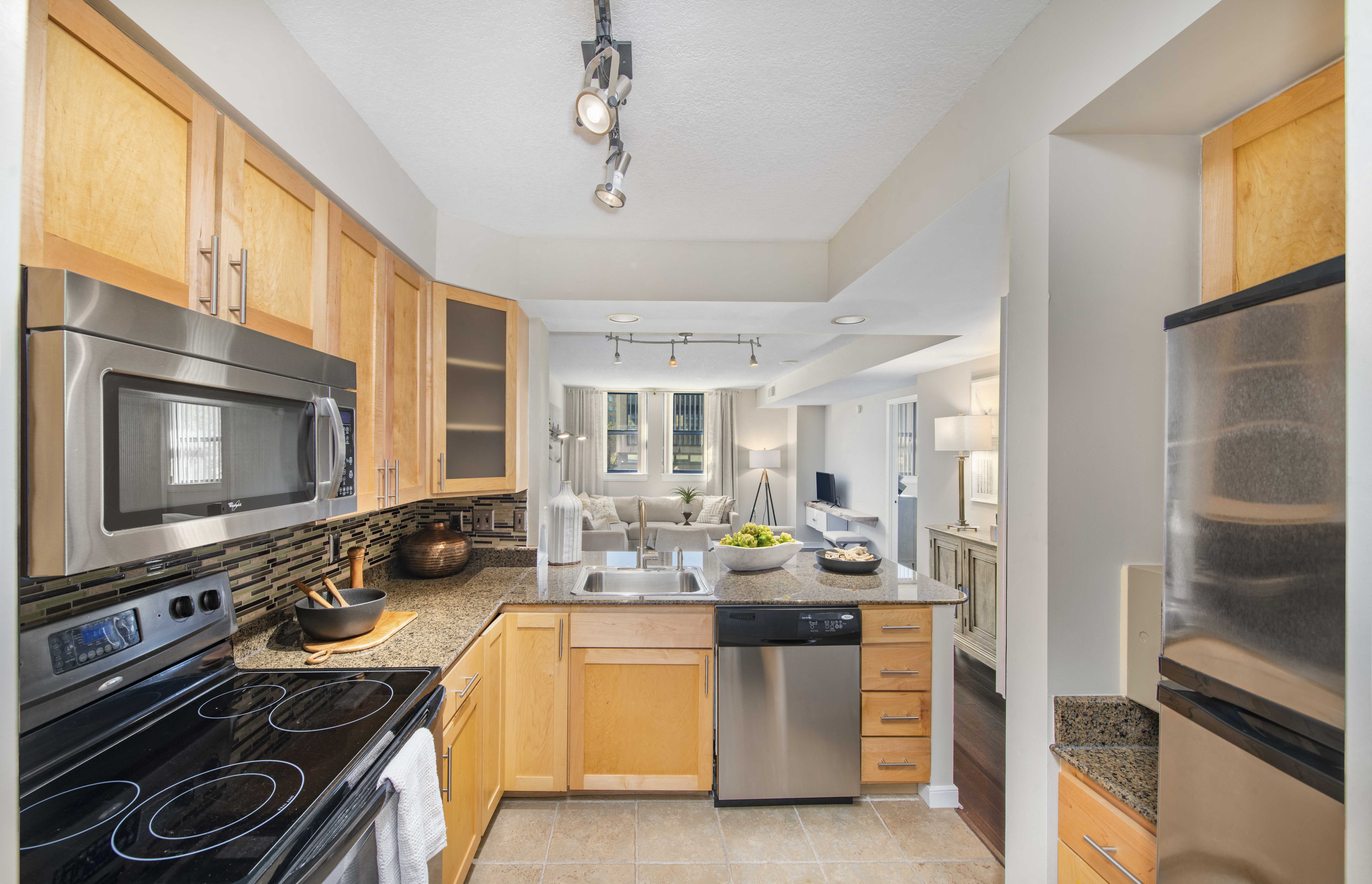 a kitchen with stainless steel appliances and wooden cabinets