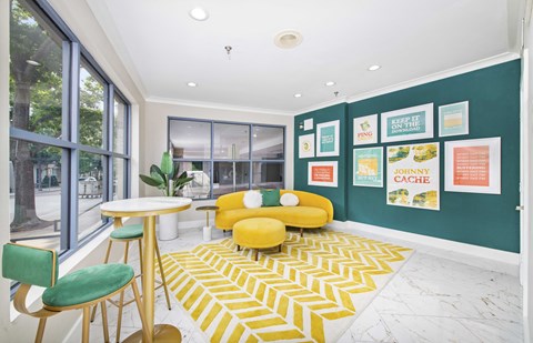 a living room with a yellow couch and a green wall