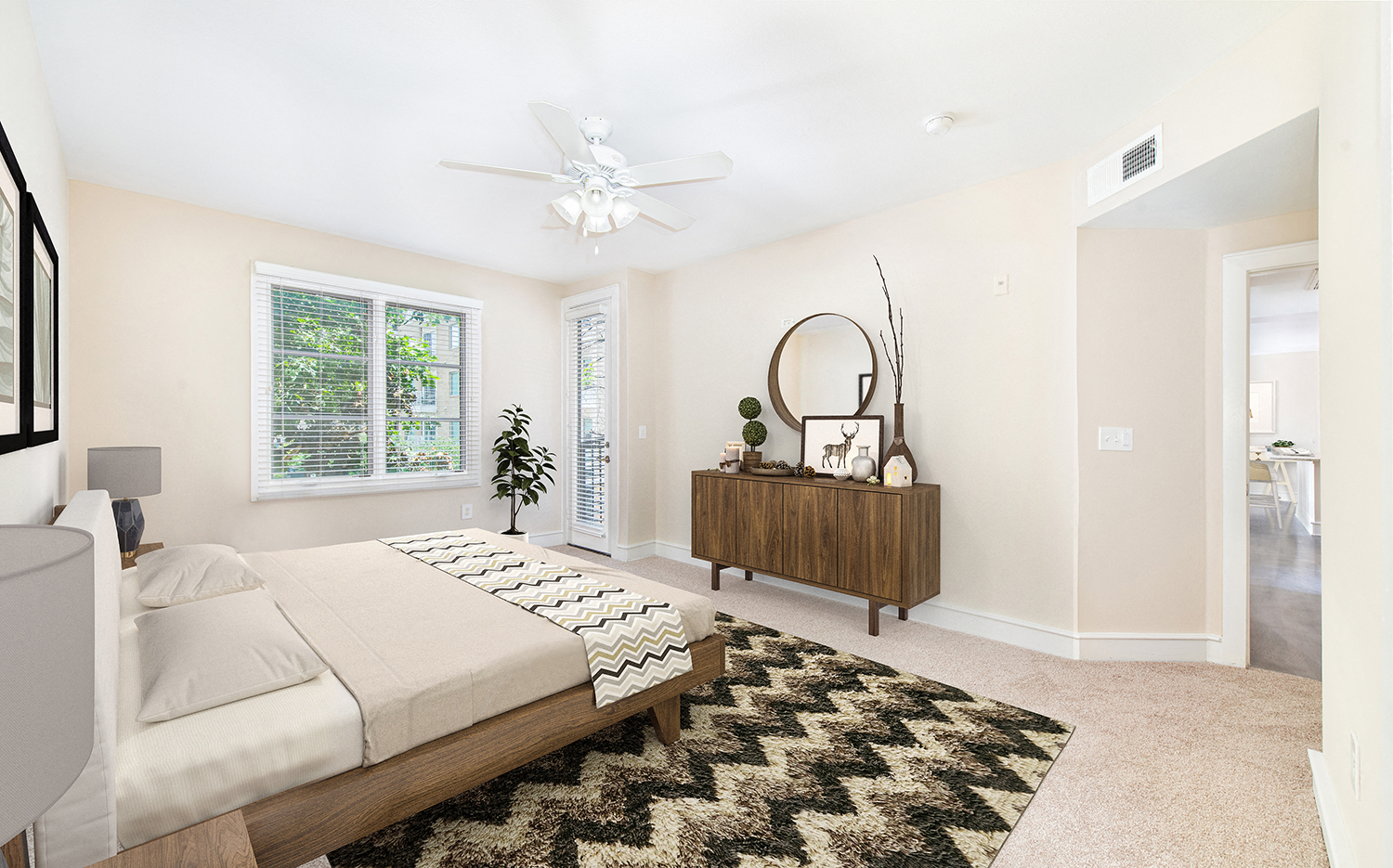 a bedroom with a bed and a dresser and a ceiling fan