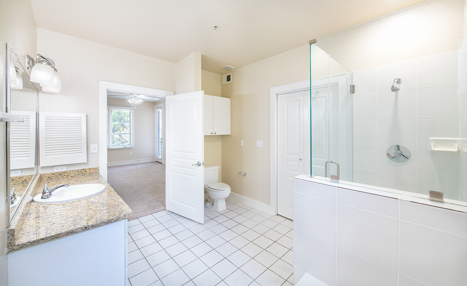 a bathroom with a shower and a sink and a toilet